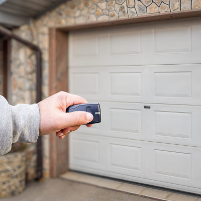 Lawrence security key fob pointing to a garage door